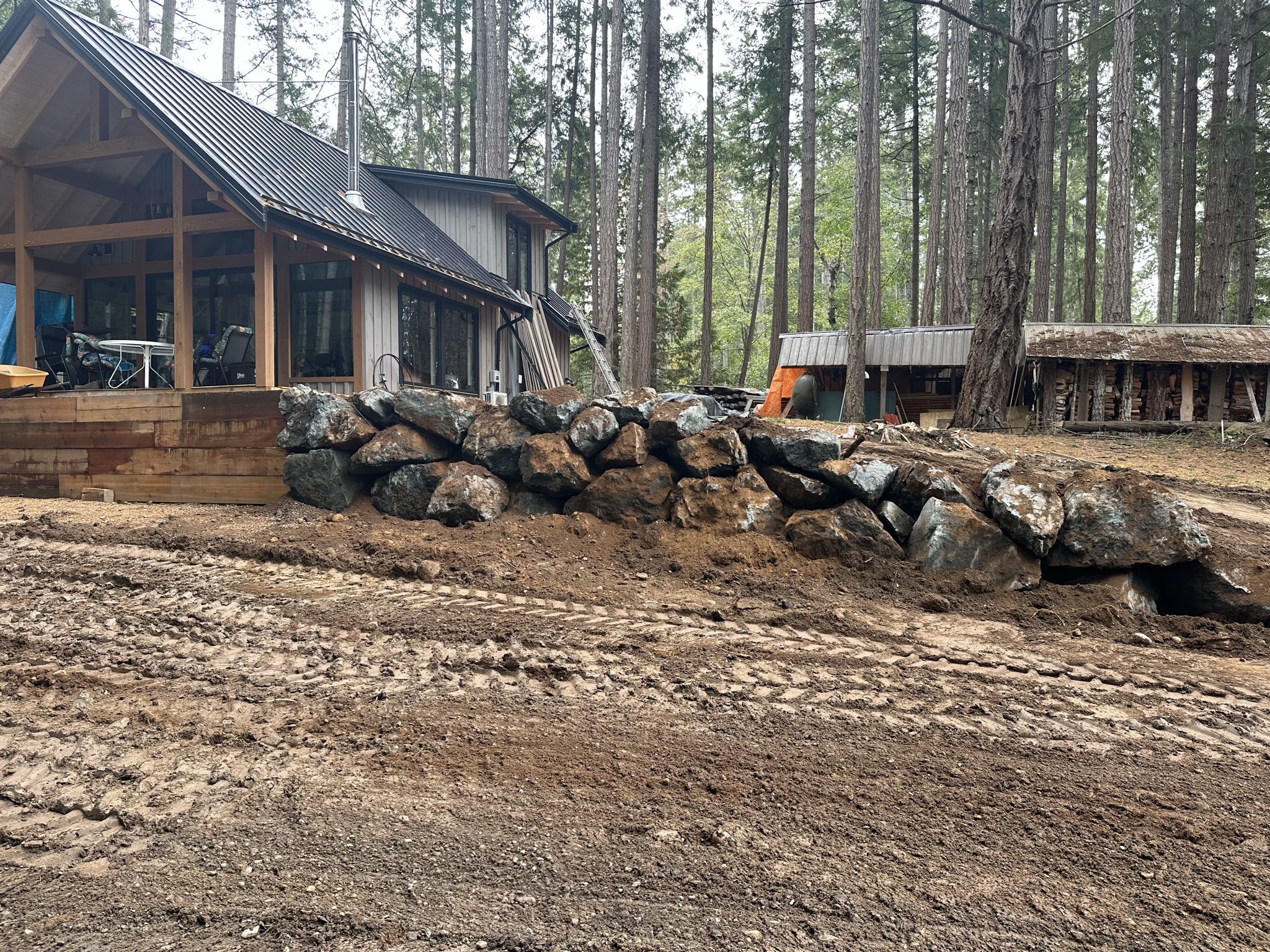 Rock wall retaining work alongside a cabin in the forest